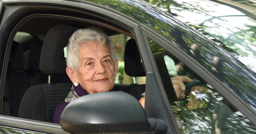 Senior woman taking driving assessment for the elderly after lessons.