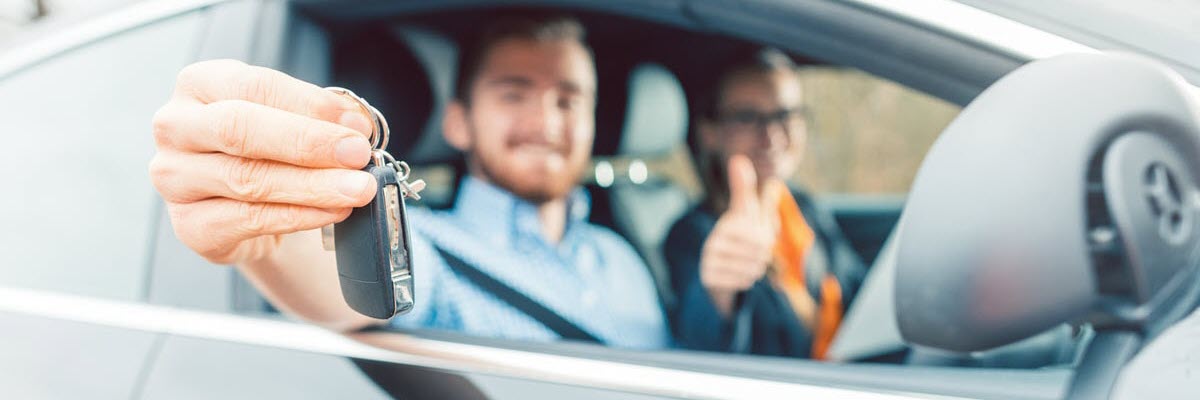 Man holding keys after booking driving test (PDA) in Perth.