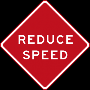 Red and white reduce speed road traffic sign.