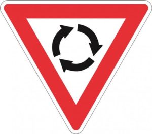 Road traffic sign highlighting roundabout ahead.