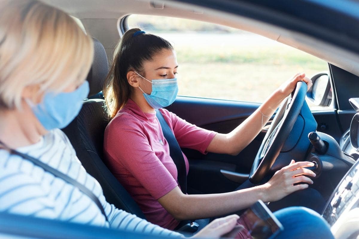 driving student and teacher wearing masks