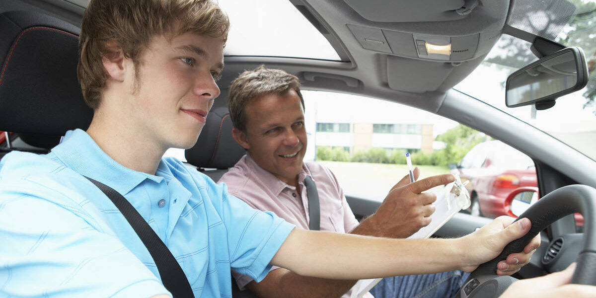 A man teaching someone to drive.
